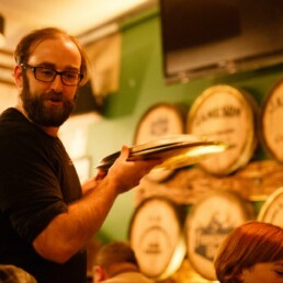 Staff member serves pizza to customers