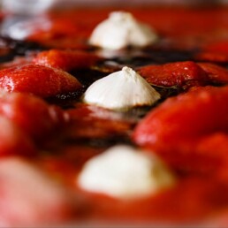 Close-up of ingredients for pizza base tomato sauce in a roasting tray