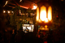Pizzaiolos working in the Pompeii Pizza outdoor kitchen, surrounded by the scenery of the beer garden at night