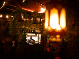 Pizzaiolos working in the Pompeii Pizza outdoor kitchen, surrounded by the scenery of the beer garden at night