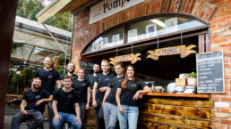 The Pompeii Pizza team at the pizzeria's service counter.