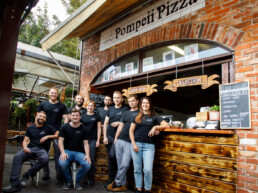 The Pompeii Pizza team at the pizzeria's service counter.