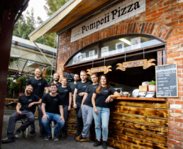 The Pompeii Pizza team at the pizzeria's service counter.