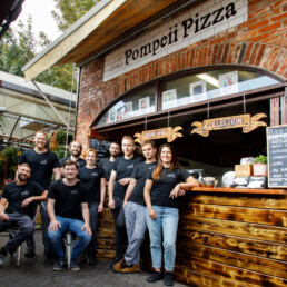 The Pompeii Pizza team at the pizzeria's service counter.