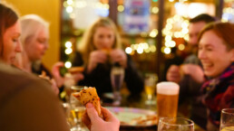 Colleagues enjoying pizza bought with pompeii pizza gift vouchers