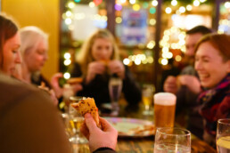 Colleagues enjoying pizza bought with pompeii pizza gift vouchers