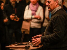 Audience watches as Master Cooper Ger Buckley presents coopering tools at pizza pairing event