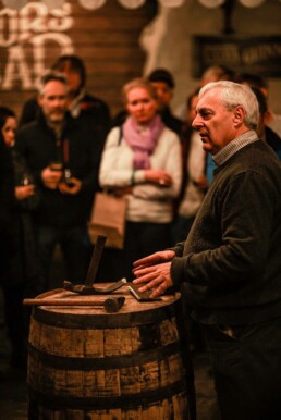 Audience watches as Master Cooper Ger Buckley presents coopering tools at pizza pairing event