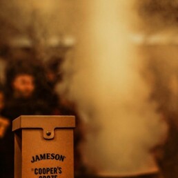 Jameson whiskey, which features in the pizza pairing menu, with a smoke rising from acharring barrel