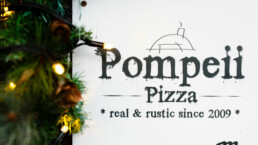 Pompeii Pizza gift vouchers surrounded by Christmas lights