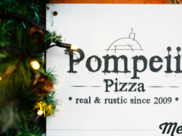 Pompeii Pizza gift vouchers surrounded by Christmas lights