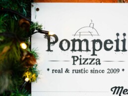 Pompeii Pizza gift voucher surrounded by christmas lights