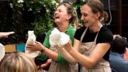 learning to stretch dough at a pizza workshop