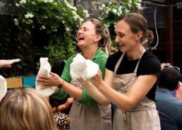 learning to stretch dough at a pizza workshop